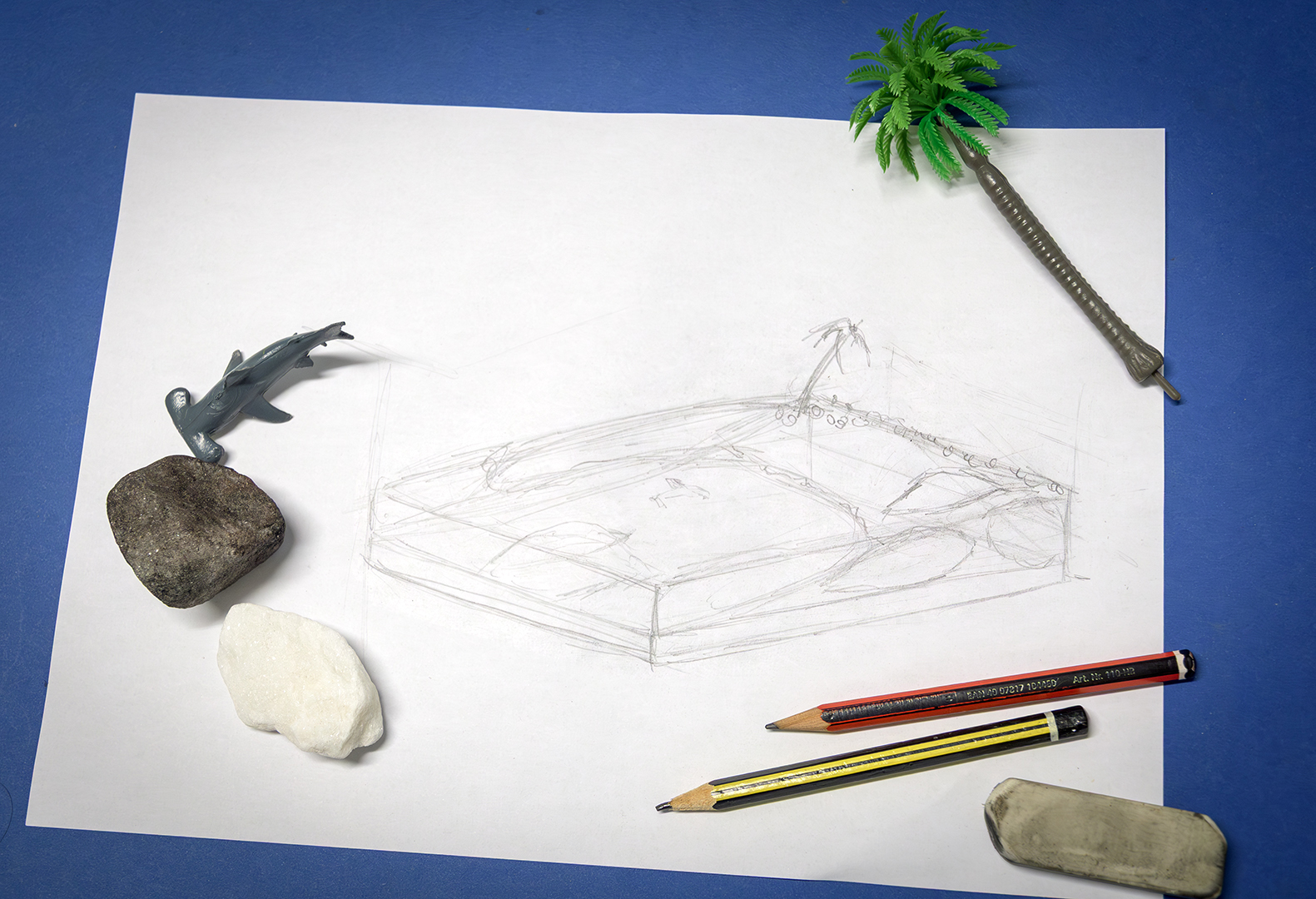A simple sketch of the project with some of the items used in the diorama. The rocks were originally white and painted darker to be more like ocean rocks.