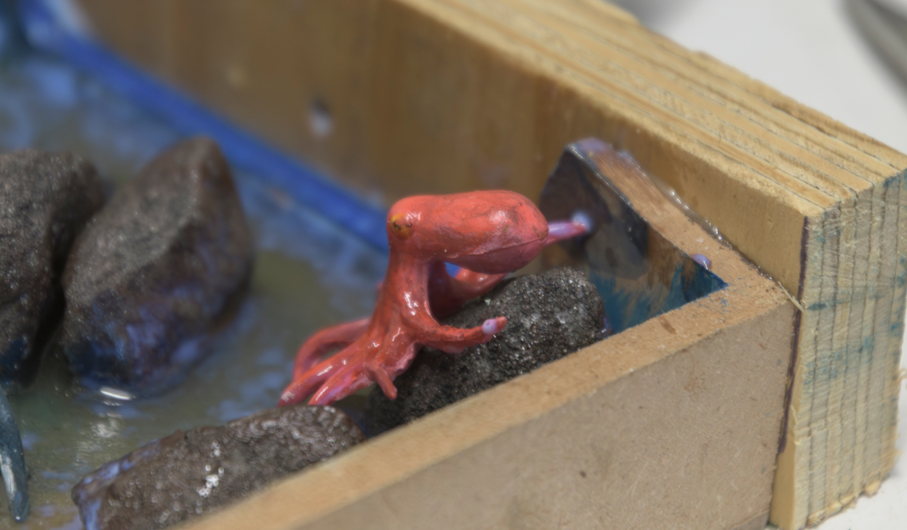The wooden piece was attached with Quickset® Clear and then sealed with Decopodge® Sealant. The sealant was applied all the way to the planned water's edge.